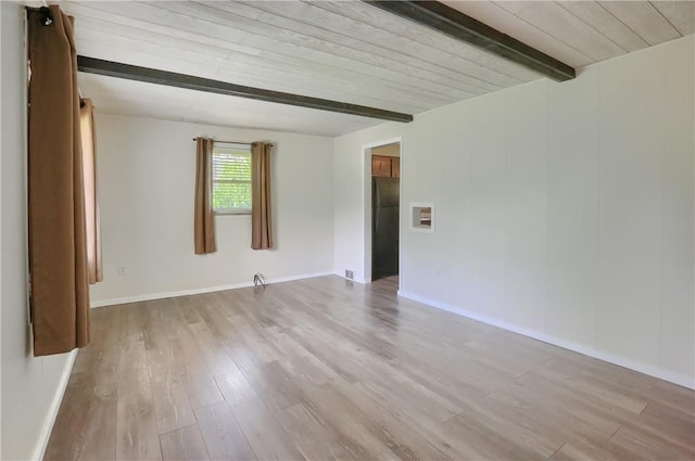 spare room featuring beam ceiling, wood finished floors, wood ceiling, and baseboards