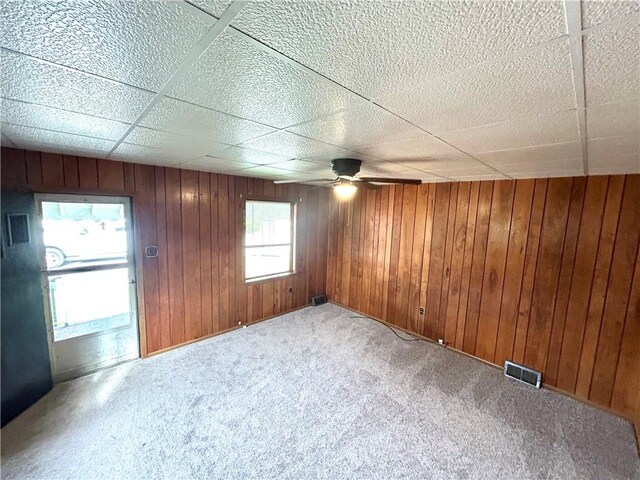 402 Vine St, South Connellsville, PA 15425 - spare room with carpet, ceiling fan, wooden walls, and a drop ceiling