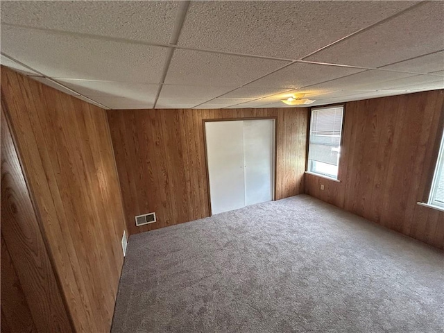 402 Vine St, South Connellsville, PA 15425 - unfurnished bedroom with wood walls, carpet floors, and a paneled ceiling
