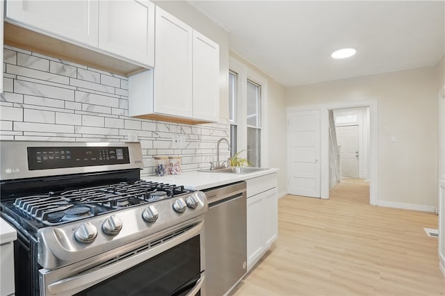3316 Alberta St, Munhall, PA 15120 - kitchen with appliances with stainless steel finishes, tasteful backsplash, white cabinetry, and light countertops