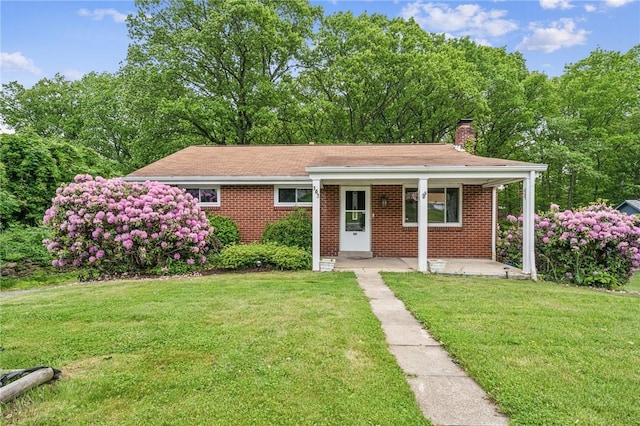 161 Reaghard Dr, West Deer, PA 15024 - view of front of property with brick siding, covered porch, a chimney, and a front yard