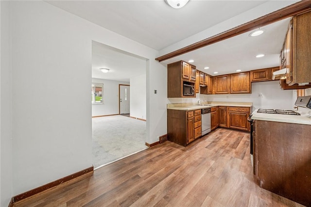 161 Reaghard Dr, West Deer, PA 15024 - kitchen featuring dishwasher, baseboards, light wood-type flooring, brown cabinets, and light countertops
