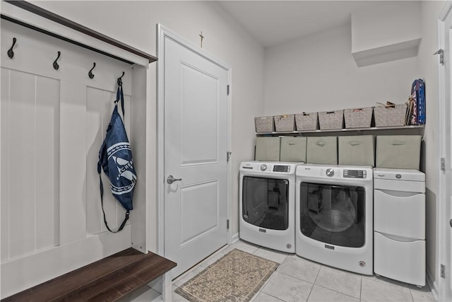 washroom featuring washing machine and dryer and light tile patterned floors