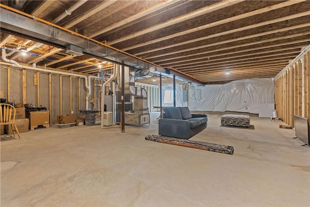 unfinished below grade area featuring water heater