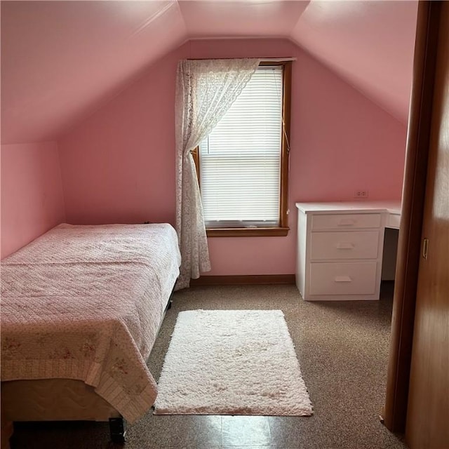 bedroom featuring lofted ceiling and light carpet