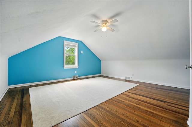 additional living space with ceiling fan, hardwood / wood-style flooring, lofted ceiling, and baseboards