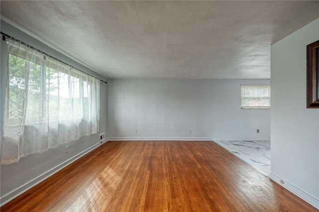 815 Londonderry Dr, Castle Shannon, PA 15234 - unfurnished room with hardwood / wood-style floors, a textured ceiling, and baseboards