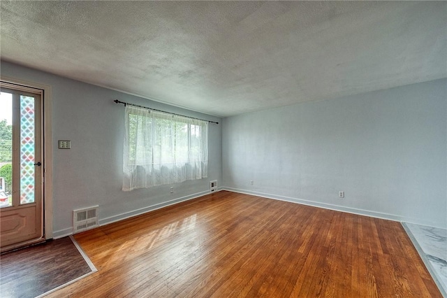 815 Londonderry Dr, Castle Shannon, PA 15234 - empty room with wood finished floors, a textured ceiling, and baseboards