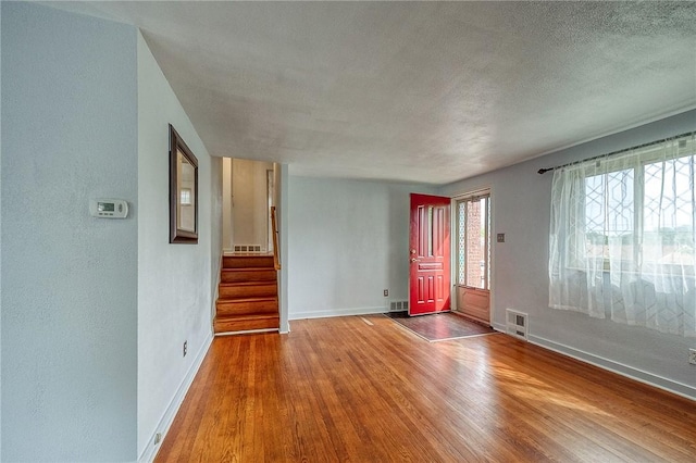 815 Londonderry Dr, Castle Shannon, PA 15234 - empty room featuring baseboards, wood finished floors, stairway, and a textured ceiling