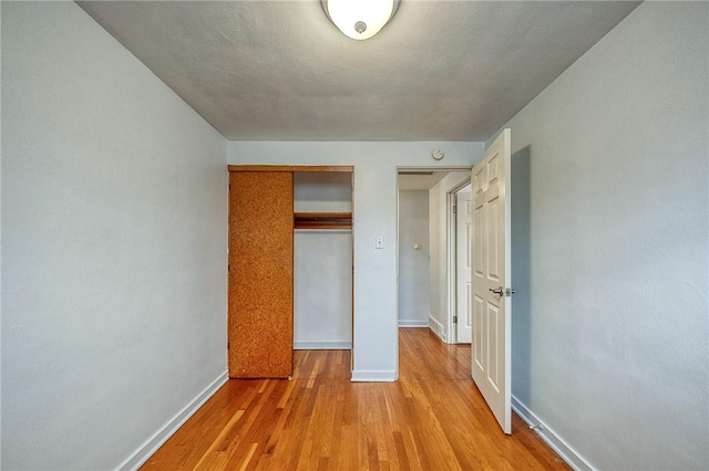 815 Londonderry Dr, Castle Shannon, PA 15234 - unfurnished bedroom featuring baseboards, light wood-type flooring, and a closet