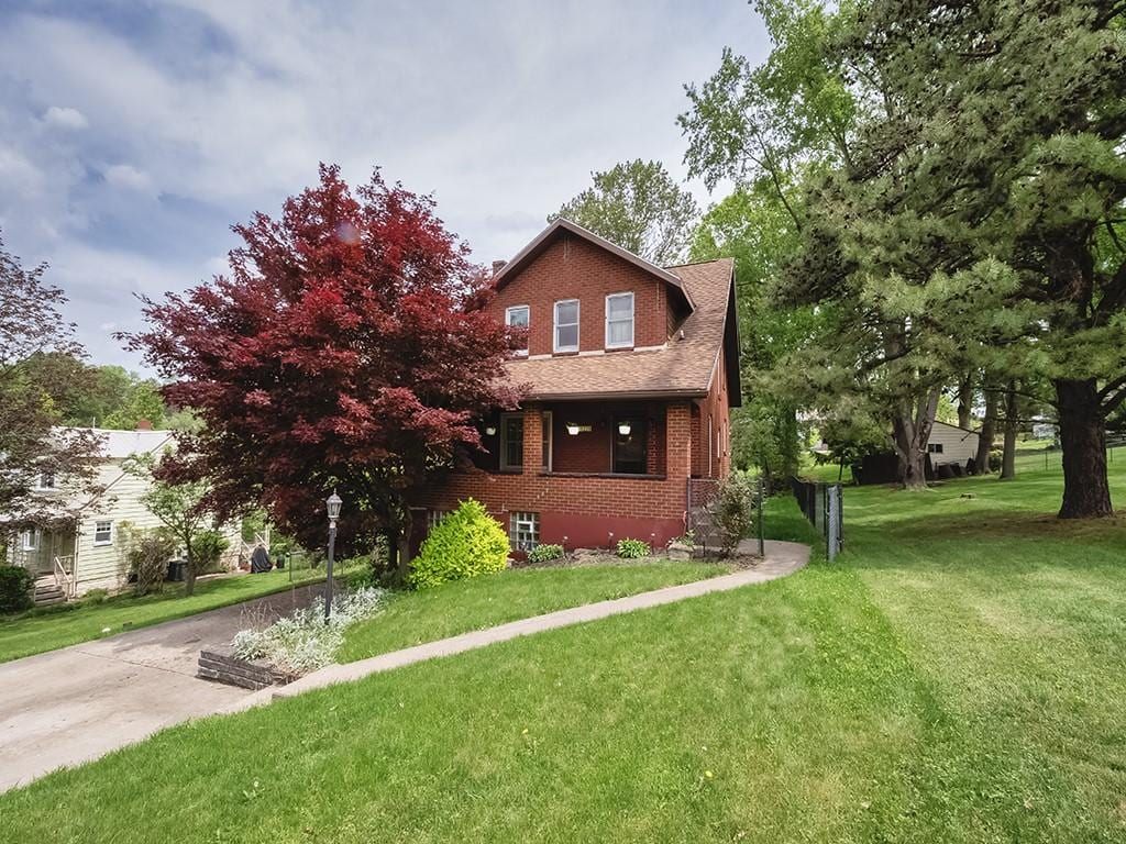 1228 Beech St, South Strabane, PA 15301 - view of front facade with brick siding and a front lawn