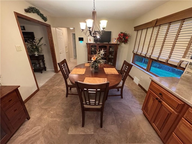 321 Crest Ave, Rostraver, PA 15012 - dining room featuring a chandelier and baseboards