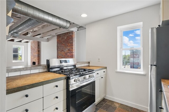5111 Penn Ave, Garfield, PA 15224 - kitchen with appliances with stainless steel finishes, baseboards, white cabinetry, recessed lighting, and dark stone finish flooring