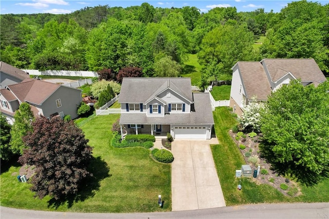 aerial view of property and surrounding area with a forest