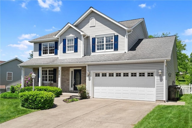 traditional-style house featuring concrete driveway, covered porch, and a shingled roof