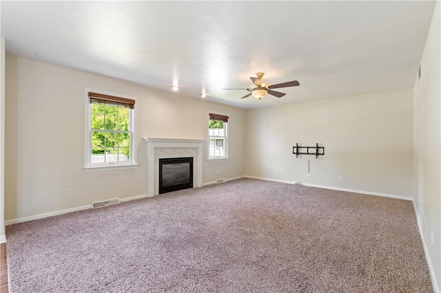 815 Kira Cir, Cranberry Twp, PA 16066 - unfurnished living room with plenty of natural light, ceiling fan, a glass covered fireplace, and baseboards