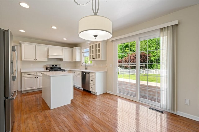 815 Kira Cir, Cranberry Twp, PA 16066 - kitchen with stainless steel appliances, baseboards, light countertops, light wood finished floors, and white cabinets