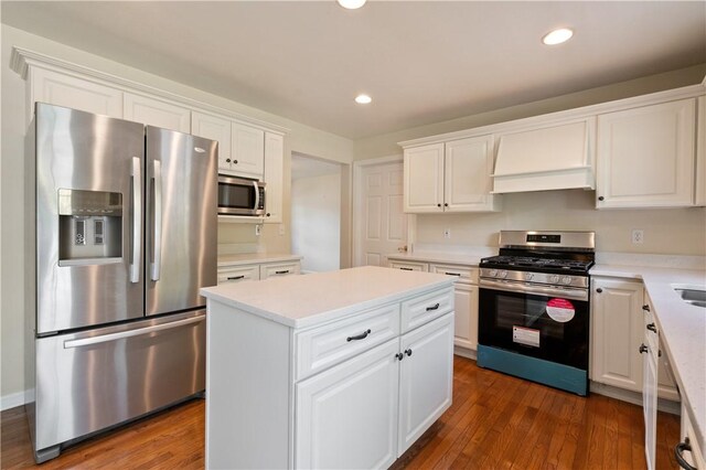kitchen with stainless steel appliances, white cabinetry, recessed lighting, light countertops, and a center island
