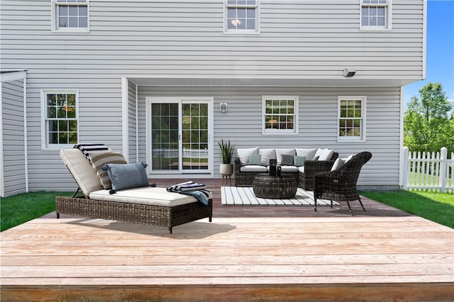 wooden deck featuring outdoor lounge area and fence