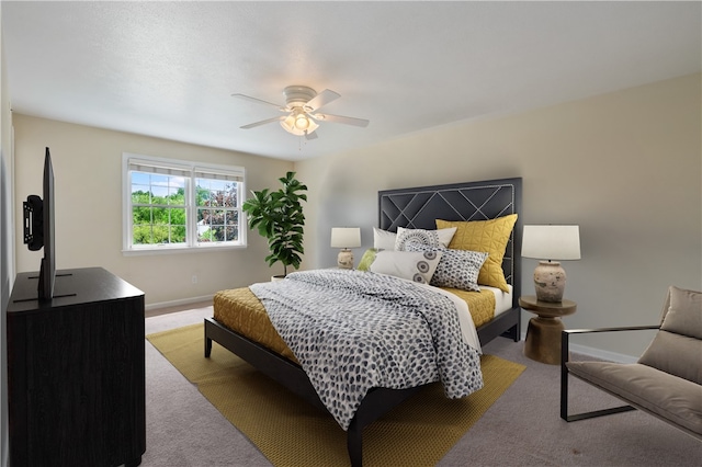 carpeted bedroom with baseboards and ceiling fan