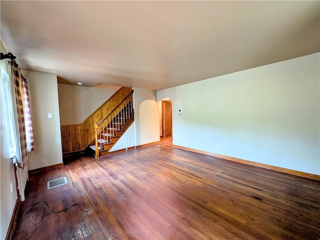 160 Frye Farm Rd, Unity Twp, PA 15601 - unfurnished living room featuring hardwood / wood-style floors, arched walkways, baseboards, and stairs