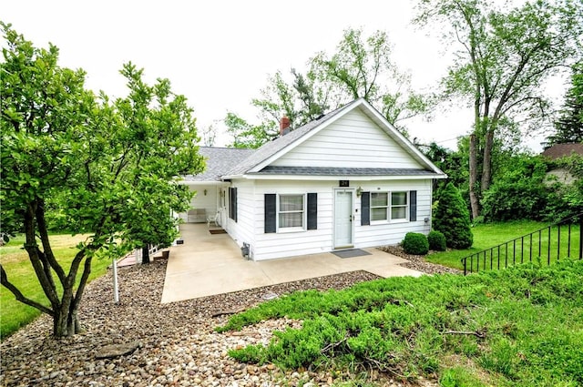24 N St, Smith, PA 15004 - view of front facade featuring a shingled roof, a front lawn, a patio, and a chimney