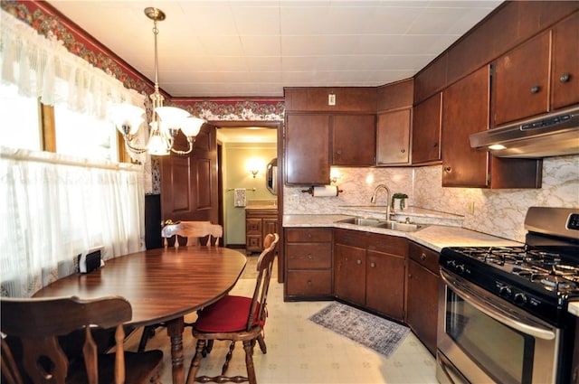 24 N St, Smith, PA 15004 - kitchen with stainless steel gas stove, a sink, under cabinet range hood, a chandelier, and light floors