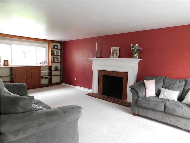 living area featuring light carpet, a brick fireplace, and baseboards