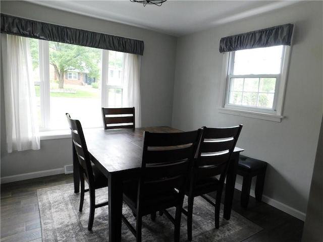 dining area featuring wood finished floors and baseboards