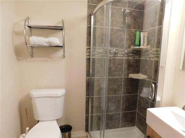 bathroom featuring a stall shower and toilet