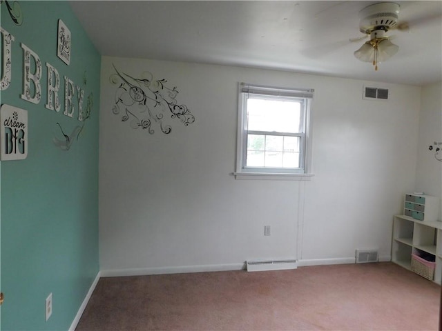 carpeted spare room featuring ceiling fan and baseboards