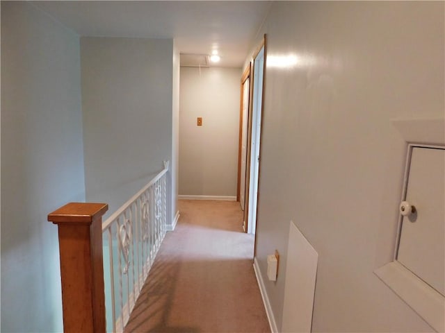 corridor with carpet and baseboards