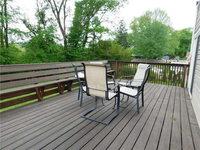 wooden deck featuring outdoor dining area