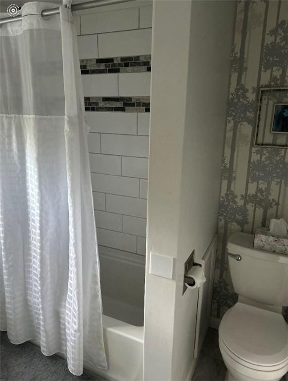 bathroom with toilet and shower / tub combo