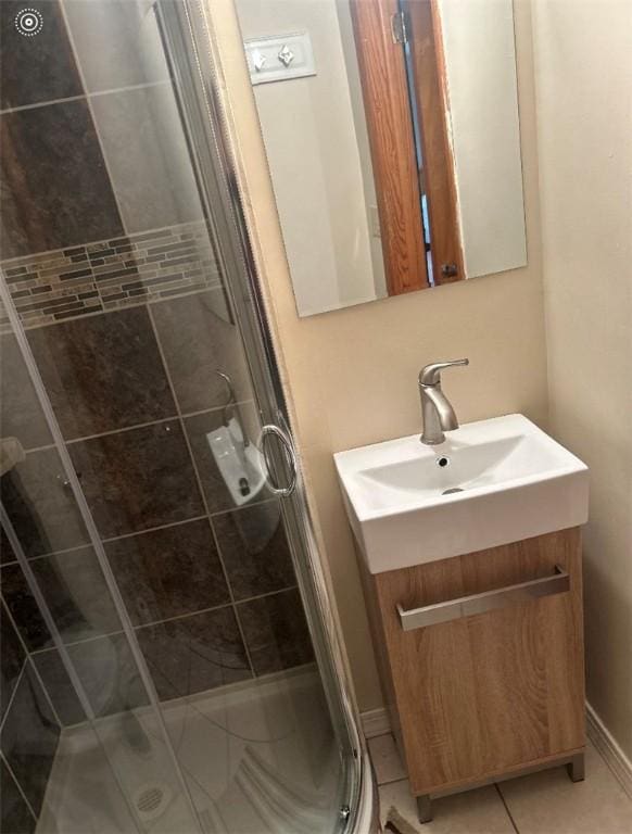 full bath featuring vanity, a stall shower, and tile patterned flooring