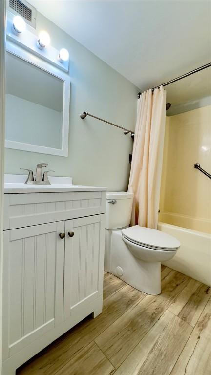 1987 Centurion Dr Unit 107, Forest Hills Boro, PA 15221 - bathroom featuring toilet, wood finished floors, shower / bath combo, and vanity
