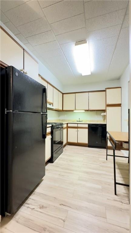 1987 Centurion Dr Unit 107, Forest Hills Boro, PA 15221 - kitchen with black appliances, light wood-type flooring, light countertops, and a sink