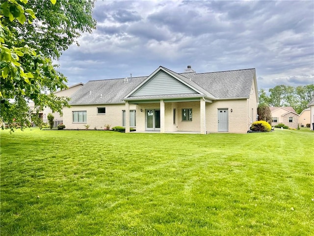 back of property with a yard