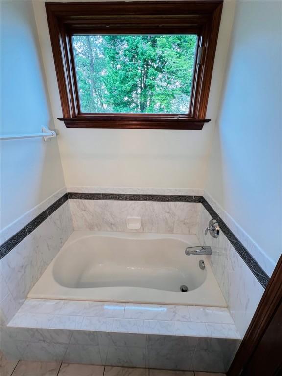 bathroom featuring plenty of natural light and a garden tub