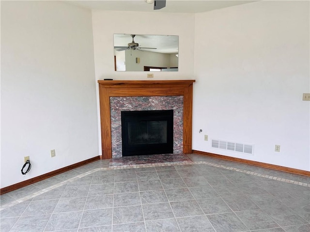 unfurnished living room featuring baseboards, a ceiling fan, a high end fireplace, and tile patterned floors
