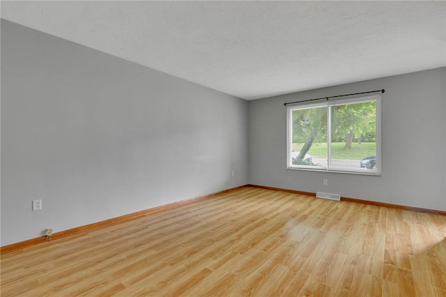907 3rd St, Baden, PA 15005 - spare room featuring wood finished floors and baseboards