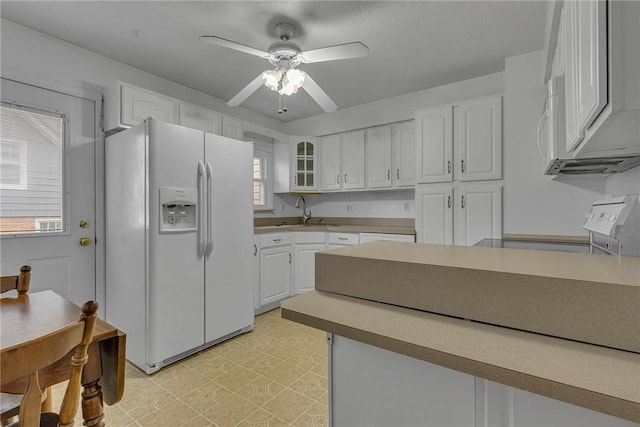 907 3rd St, Baden, PA 15005 - kitchen with white appliances, light floors, white cabinets, a ceiling fan, and glass insert cabinets