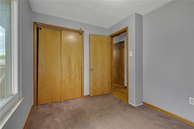 907 3rd St, Baden, PA 15005 - unfurnished bedroom featuring carpet flooring, baseboards, a closet, and a textured ceiling