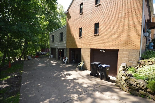 43 Bellevue Ave, West View, PA 15229 - view of side of property with an attached garage, driveway, and brick siding