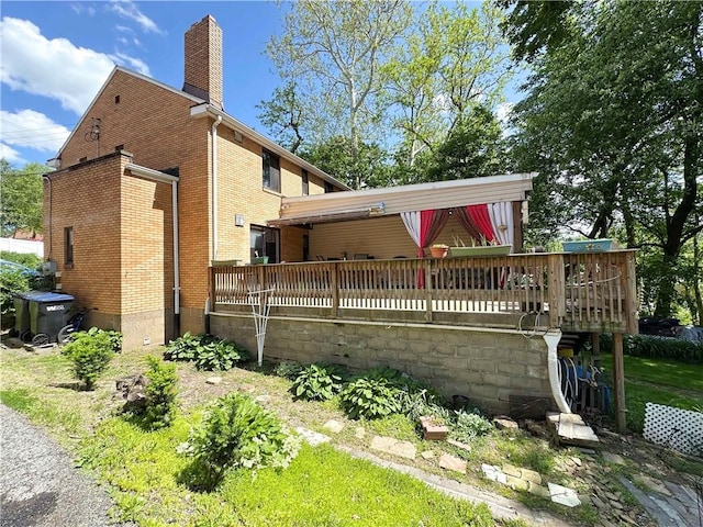43 Bellevue Ave, West View, PA 15229 - rear view of property featuring brick siding, a chimney, and a deck