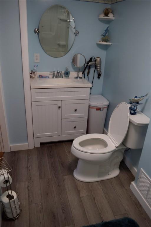 333 Baum Rd, Derry Twp, PA 15627 - bathroom with wood finished floors, toilet, vanity, and baseboards
