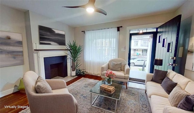 912 N Saint Clair St, Highland Park, PA 15206 - living room with wood finished floors, a ceiling fan, a fireplace, and baseboards