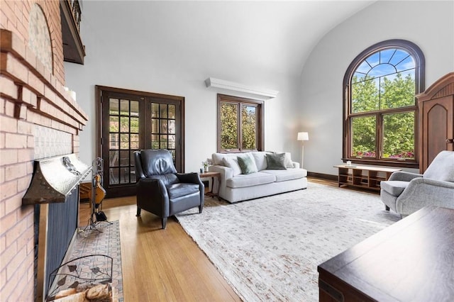 218 Barth Ave, Mt Lebanon, PA 15228 - living area featuring lofted ceiling, light wood-style flooring, healthy amount of natural light, and a brick fireplace