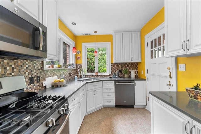 218 Barth Ave, Mt Lebanon, PA 15228 - kitchen featuring appliances with stainless steel finishes, a sink, dark countertops, and white cabinets