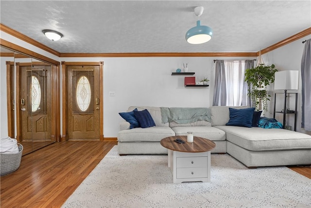1265 Norberry Ct Unit 18, Cranberry Twp, PA 16066 - living room featuring ornamental molding, wood finished floors, a textured ceiling, and baseboards